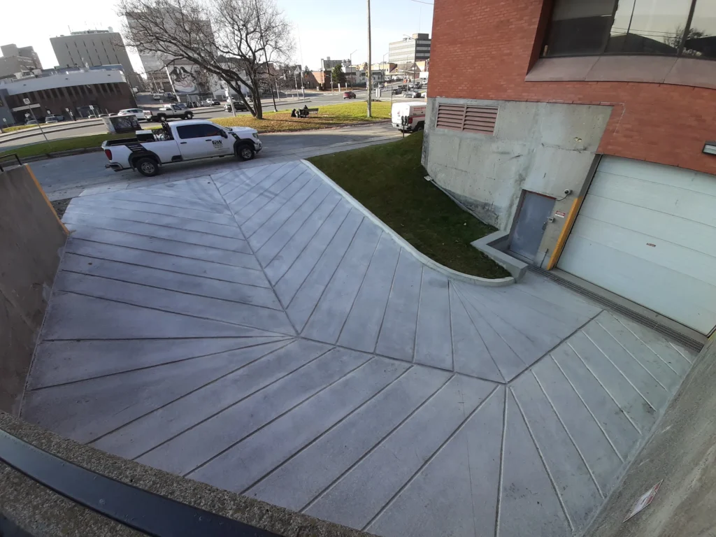 Concrete Ramp seen from above made from angled concrete panels converging down and towards the centre
